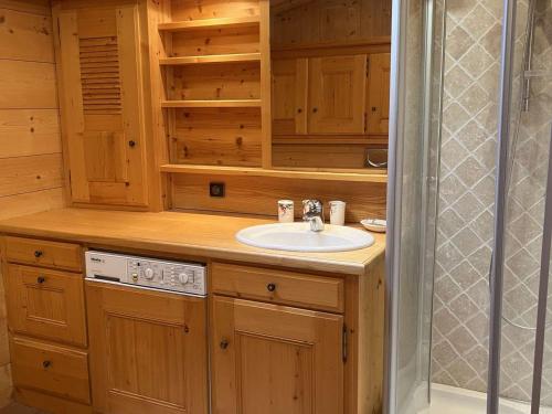 a wooden bathroom with a sink and a shower at Appartement Megève, 2 pièces, 4 personnes - FR-1-597-169 in Megève
