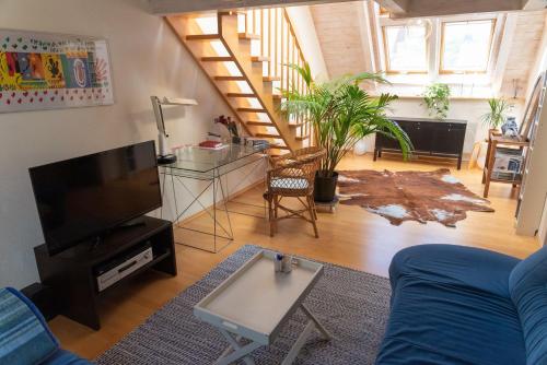 a living room with a couch and a flat screen tv at Ferienwohnung-Spessart in Straßbessenbach