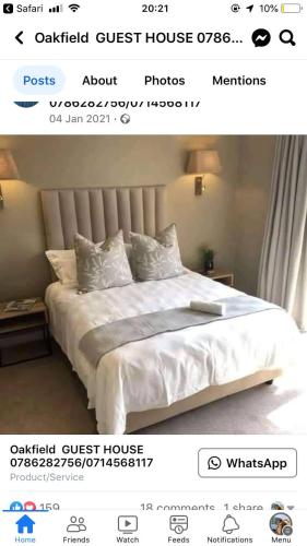 a page of a bedroom with a bed with white sheets at Oakfield lounge in Benoni