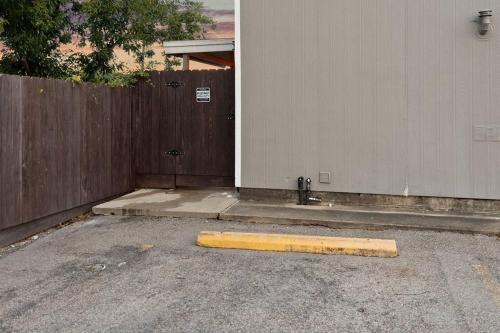 a yellow curb in a parking lot next to a fence at Sunnyside Retreat in Bacliff