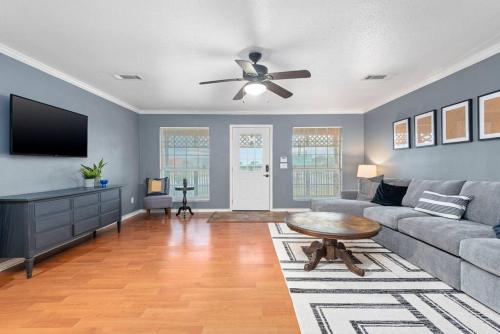 a living room with a couch and a ceiling fan at Sunnyside Retreat in Bacliff