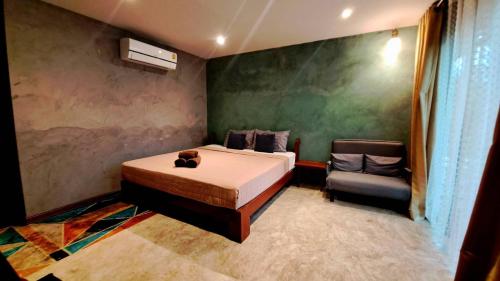 a bedroom with a bed and a chair in it at River CoCo @ Amphawa in Samut Songkhram