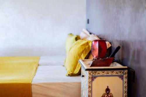 a bedroom with a bed and a table with a night stand at Chillax room for 3P in Imsouane