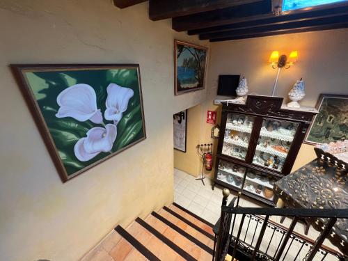 a staircase in a store with a painting on the wall at La Ventana in Ibiza Town