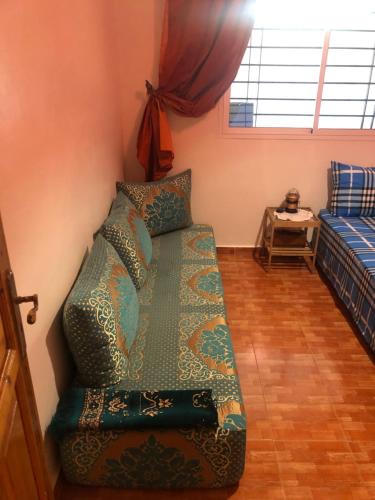 a living room with a couch and a bed at Sidi bouzid in Douar Zeraoula