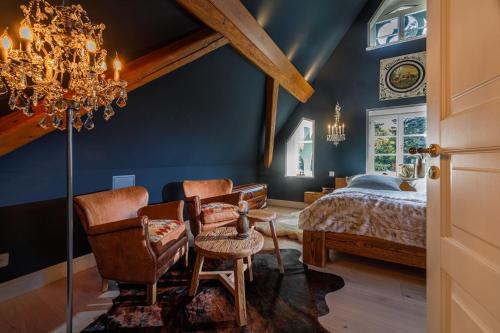 - une chambre avec un lit et un lustre dans l'établissement Luxus Hotel Design Villa Ottilienruh Ilsenburg im Harz, à Ilsenburg