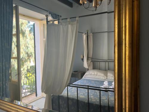 a bedroom with a canopy bed and a window at La Ventana in Ibiza Town