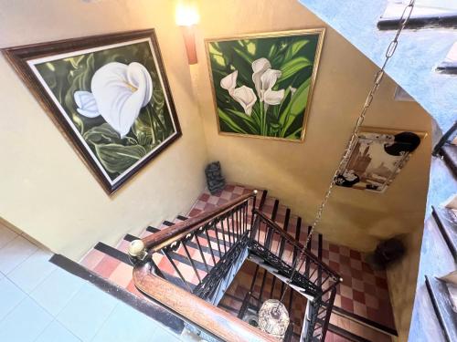 an overhead view of a staircase with paintings on the wall at La Ventana in Ibiza Town
