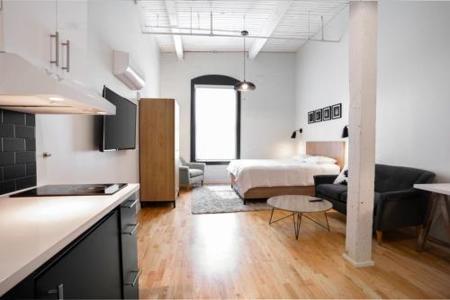 a kitchen and a living room with a bed in a room at Trumbull Apartments Elevator WI-FI XL CENTER Hartford CT in Hartford