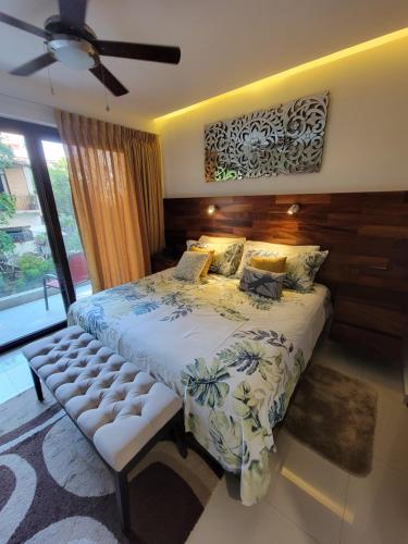 a bedroom with a large bed and a ceiling fan at Nayri Beach and restaurant row in Puerto Vallarta
