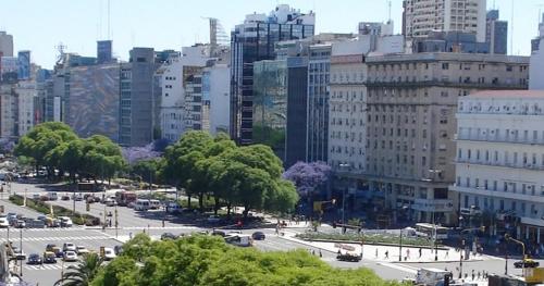 a city with a lot of buildings and a street with cars at HTL 9 de Julio BsAs in Buenos Aires