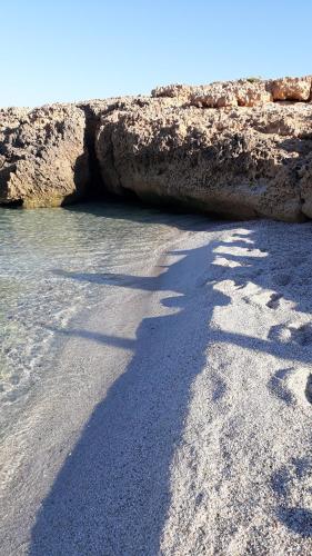 a shadow of a person on the beach at Casa Lilla 1 e 2 in Oristano