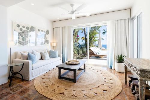 a living room with a couch and a table at Luxurious 5bd Del Mar Palmilla Villa Staffed and Swimmable Beach in San José del Cabo