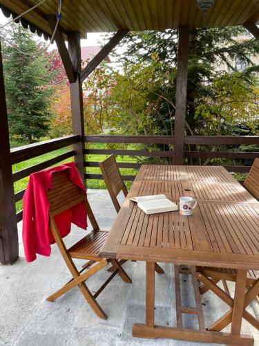 patio con tavolo da picnic in legno e sedie. di Cheerful 4-bedroom & kids friendly home a Predeal