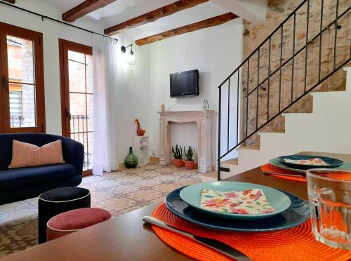 a living room with a table with plates of food on it at Cal Passió in Vimbodí