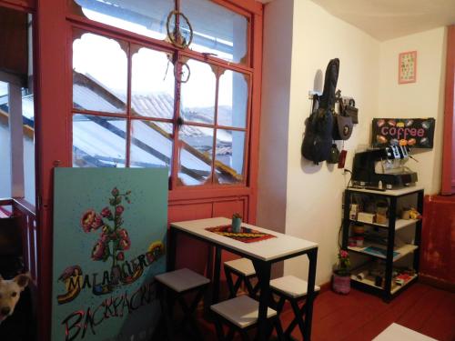 a room with a small table and a window at MALA HIERBA in Cusco