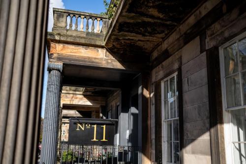 an entrance to a building with a sign on it at No11 Boutique Hotel & Brasserie in Edinburgh