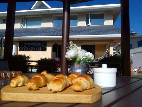 a group of croissants on a cutting board on a table at Hotel Sumaq Kay in Cumbayá