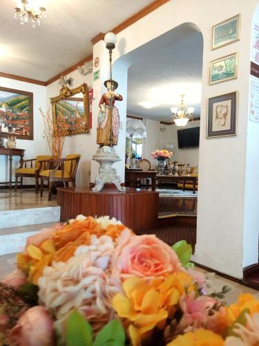 a bouquet of flowers on a table in a room at Hotel Sumaq Kay in Cumbayá