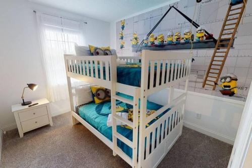 a white bunk bed in a room with a ladder at Beautiful townhouse with pool close to Disney in Davenport