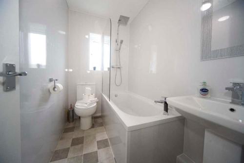 a white bathroom with a toilet and a sink at Belmont Budget Apartment in Stockton-on-Tees