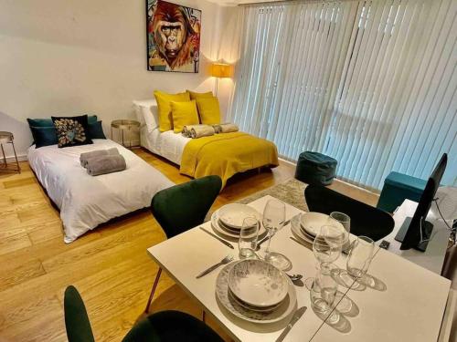 a living room with a table and a bed at Gorgeous apartment with free parking & breakfast near city centre & midday checkout in Bristol