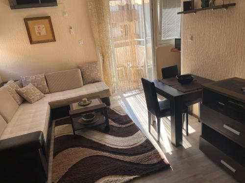 a living room with a couch and a table at Studio Apartment for rent in Budva in Budva