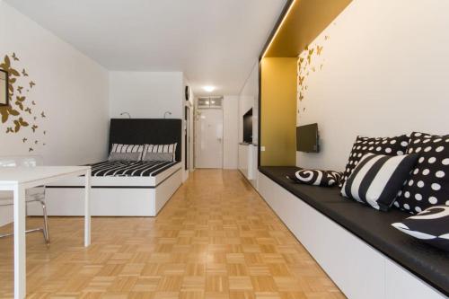 a room with a bed and a desk and a table at Gorgeous central flat with garage in Ljubljana