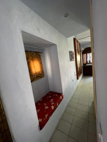a hallway with a red couch in a wall at La Ventana in Ibiza Town