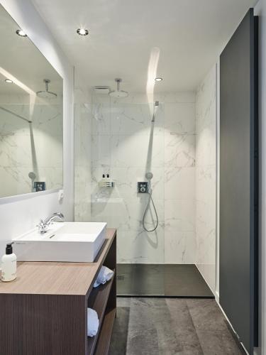 a bathroom with a sink and a shower at Boutique Hotel Ter Wallen in Izegem
