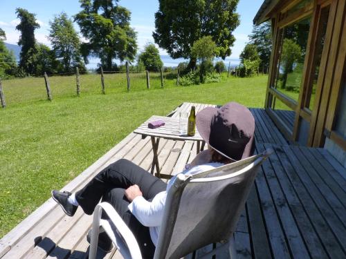 a man sitting in a chair next to a table at Lodge El Taique in Puyehue