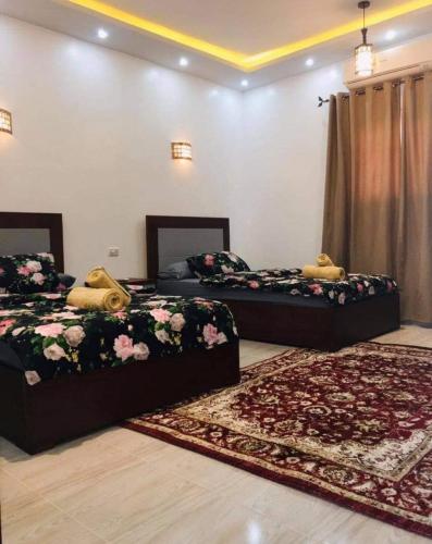 two beds in a room with two rugs at Villa Sky in Hurghada