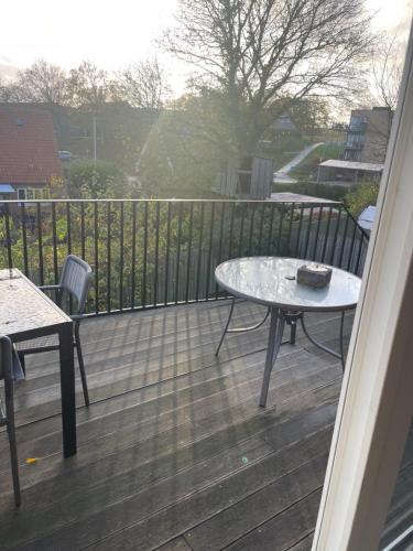 a balcony with a table and a cake on it at Hilmor's Lejligheder in Viborg