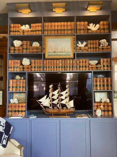a museum with a model of a boat on a shelf at Coppersmith Inn Bed And Breakfast in Galveston