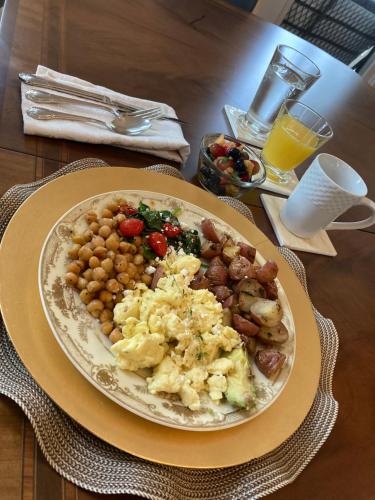 a plate of breakfast food on a table at Coppersmith Inn Bed And Breakfast in Galveston