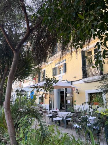 a restaurant with tables and chairs in front of a building at La Ventana in Ibiza Town