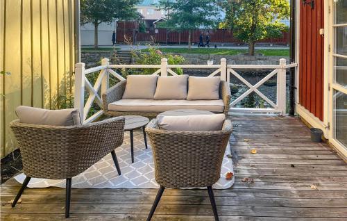 a patio with two chairs and a couch on a deck at Nice Home In Norrtälje With Wifi in Norrtälje