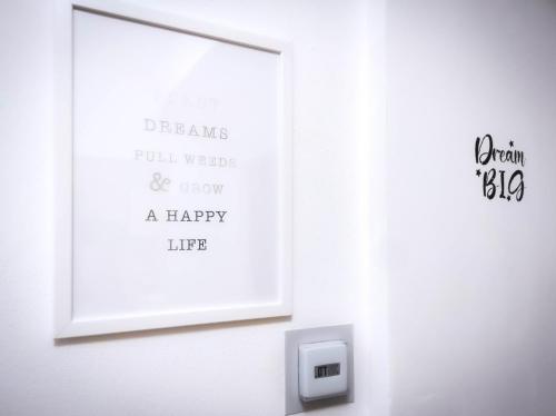 a picture frame hanging on a wall with a sign at Appartamento incantevole con camino - EDOLO74 in Edolo