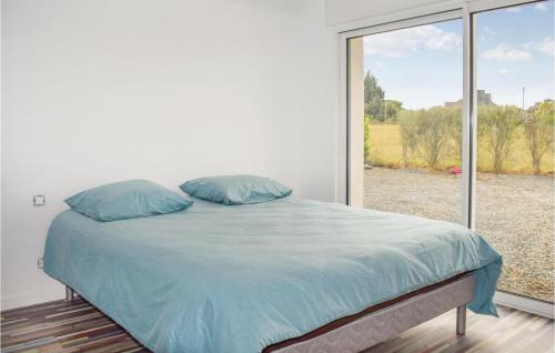 PlouézecにあるAmazing Home In Plouzec With Wifiの大きな窓付きの客室のベッド1台分です。