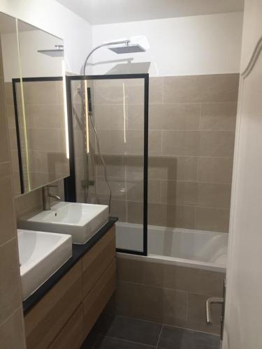 大諾瓦西的住宿－Bel appartement à 2 min des transports parisiens，浴室配有盥洗盆和浴缸。