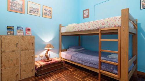a bedroom with two bunk beds and a lamp at Beraja Family Hostel in Lima
