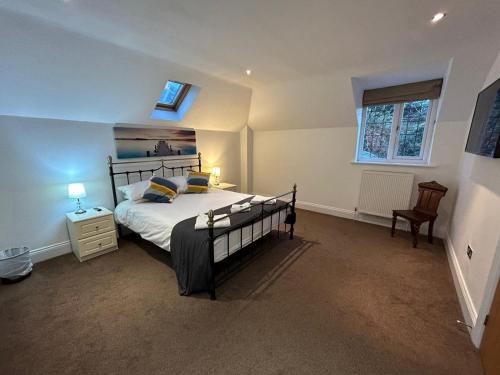 a bedroom with a large bed and a window at Castlebar in Great Singleton