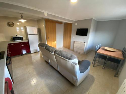a living room with a couch and a table at Casa do Adro in Lavacolhos