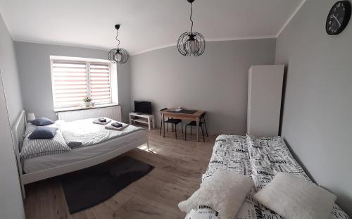 Posteľ alebo postele v izbe v ubytovaní Apartament Kilińskiego
