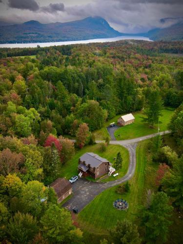 an aerial view of a house in the middle of a forest at HGTV Log Cabin near Lake Willoughby, Burke, Jaypeak ang Kingdom Trails in Barton