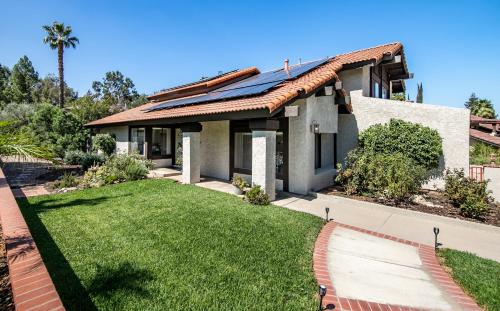 a house with a green lawn in front of it at Peaceful Private Retreat In The Heart Of Town in Redlands