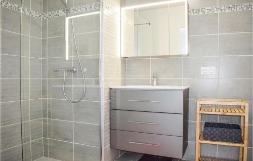 a bathroom with a sink and a shower at Stunning Apartment In Saint Quay Portrieux With House Sea View in Saint-Quay-Portrieux