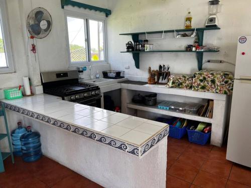 a kitchen with a stove and a counter top at Monterrico Casablanca in Chiquimulilla