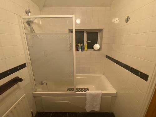 a bathroom with a shower and a bath tub at Cosy City Centre Guest Room Shared Home in Galway