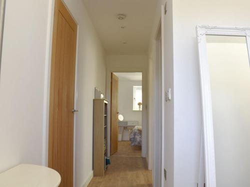 a hallway with a door leading into a room at Secretseaview in West Mersea